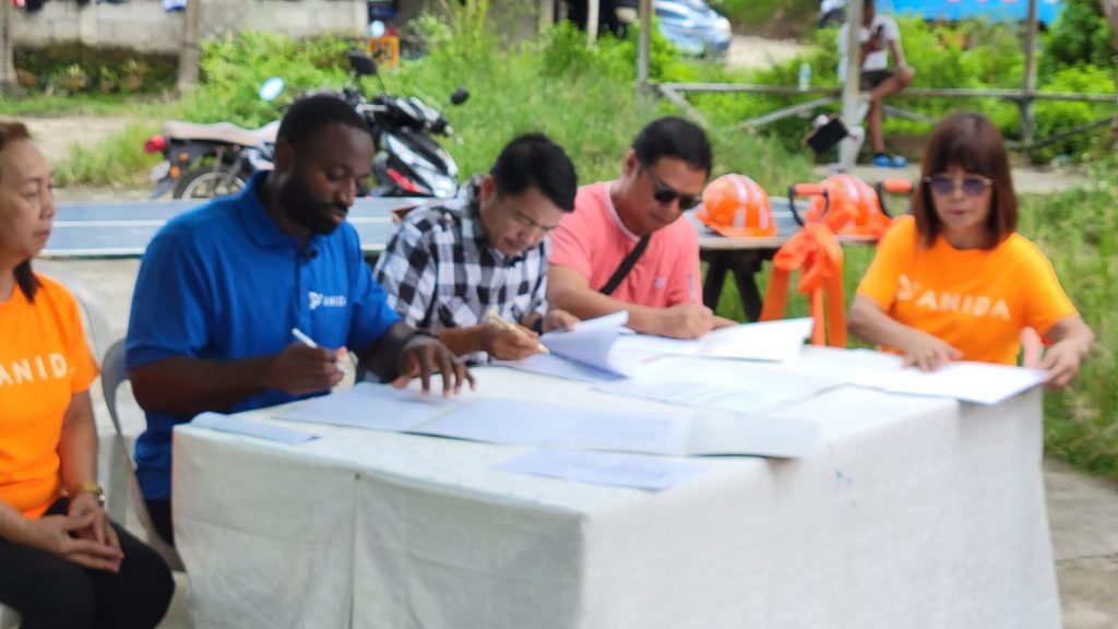 ANIDA and community leaders meeting around a table