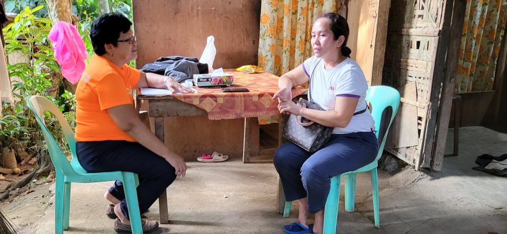 ANIDA staff listening to a family during a home visit