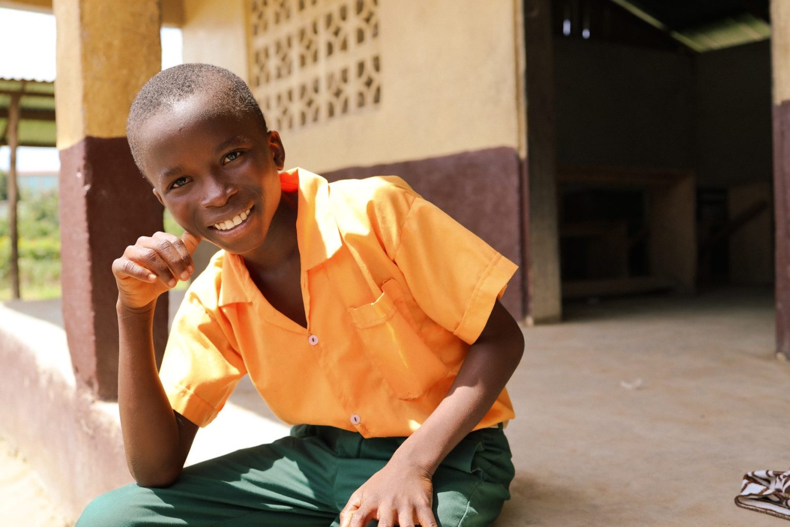 A student in an orange uniform in Liberia